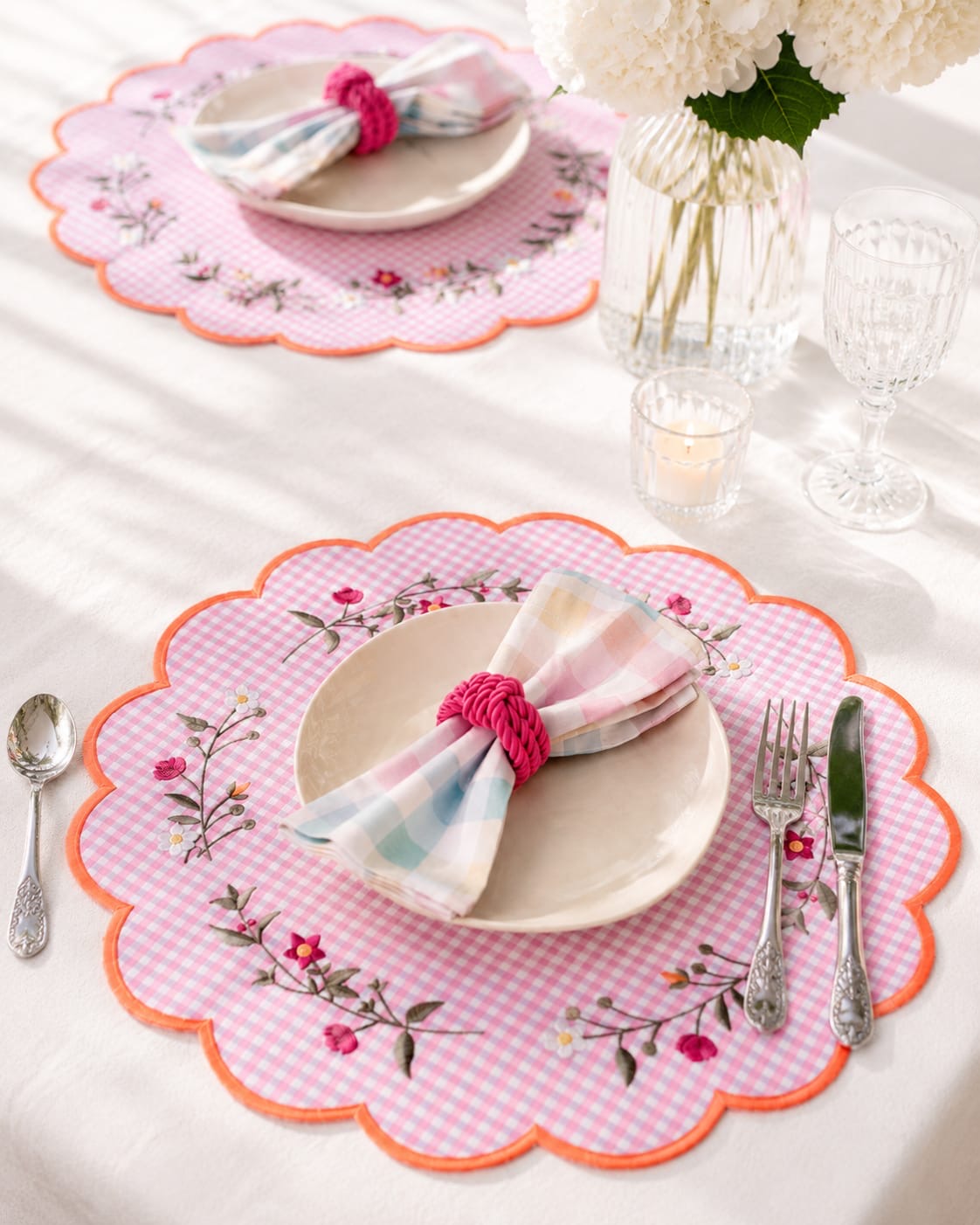 Luxury handmade pink floral embroidered placemat with matching napkin and handmade napkin ring styled on an elegant dining table.